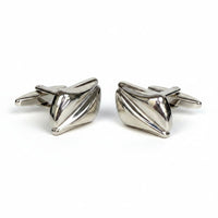 Pair of silver bow-shaped cufflinks on a white background