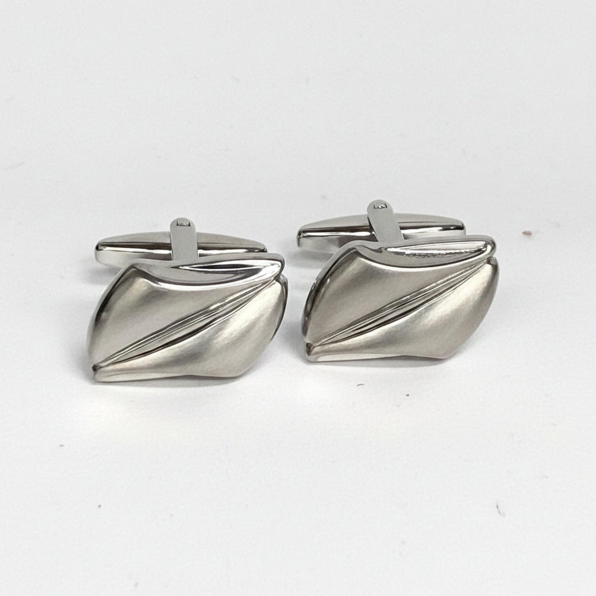 Pair of silver cufflinks on a white background