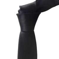 A close-up of a black necktie tied in a knot, shown against a plain white background.