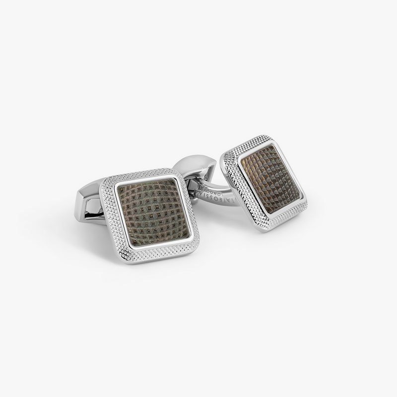 Pair of silver cufflinks with brown textured centers on a white background