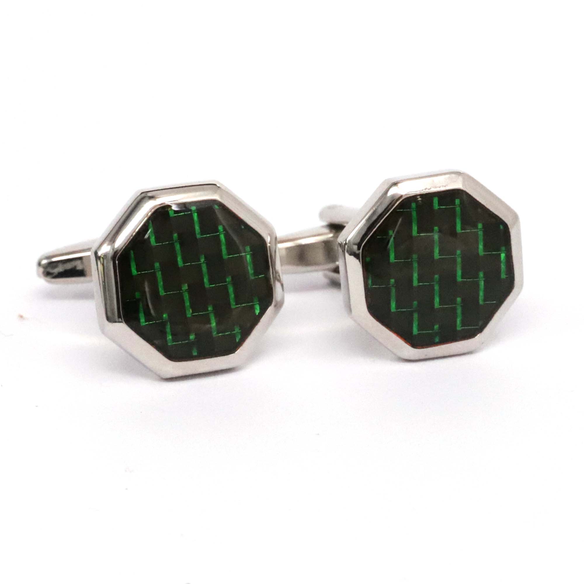 Hexagonal cufflinks with green and black pattern on a white background
