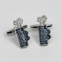 A pair of Golf silver cufflinks shaped like stacked blue and white enamel cups, photographed on a light gray background.