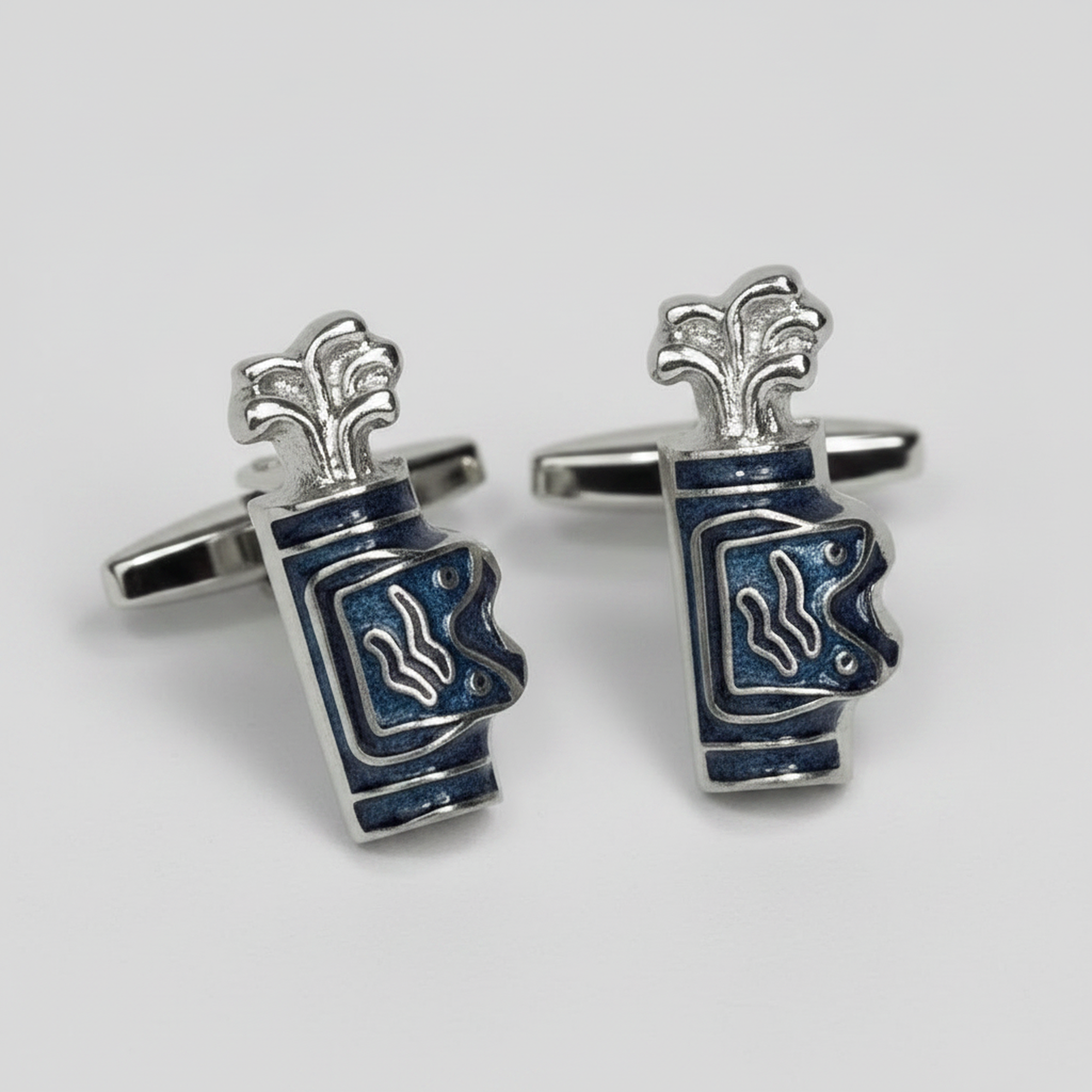 A pair of Golf silver cufflinks shaped like stacked blue and white enamel cups, photographed on a light gray background.