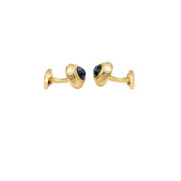 A pair of gold cufflinks with textured dome-shaped fronts and faceted black oval centers, shown on a clean white background.