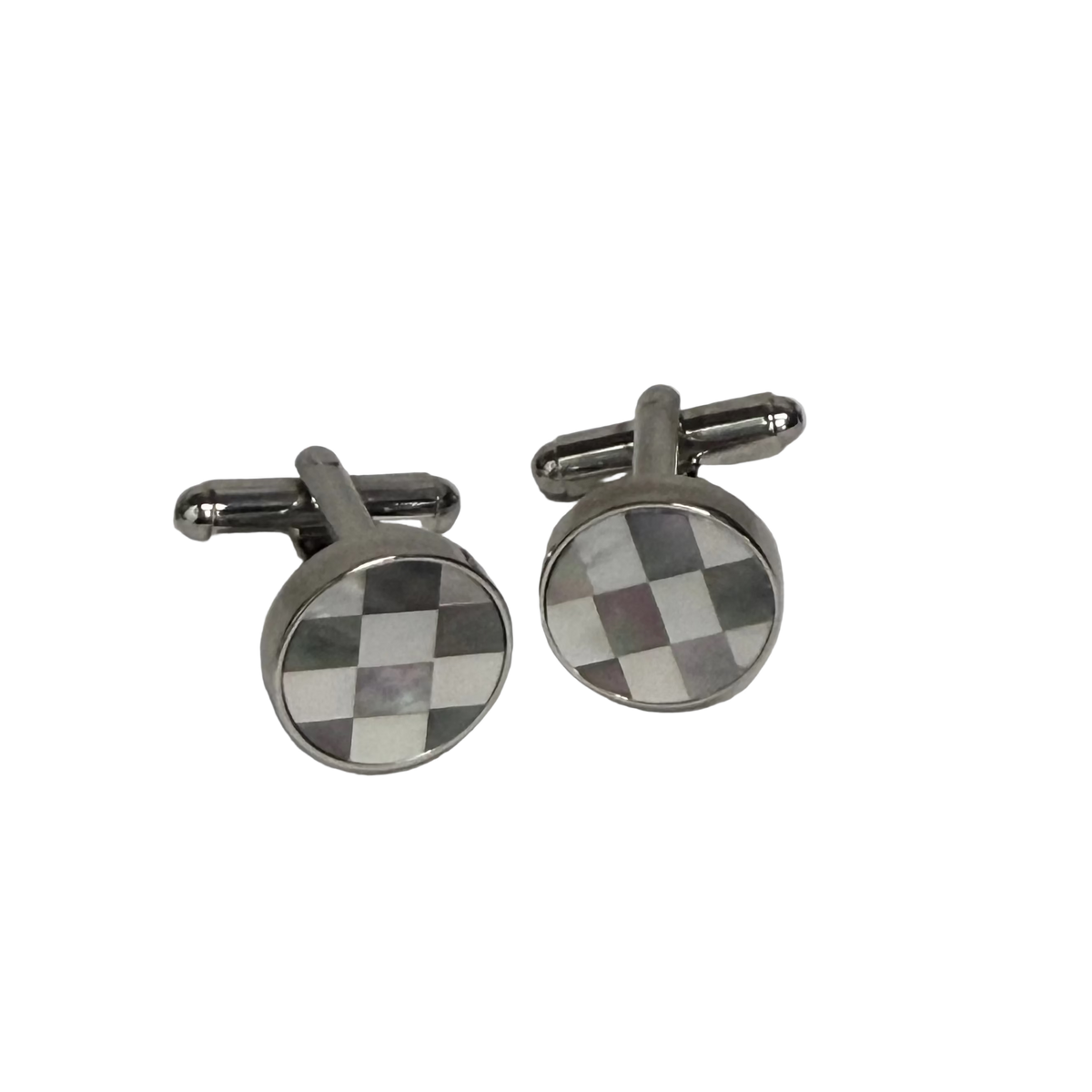A pair of round silver-toned cufflinks with a checkered pattern in brown, white, and gray mother-of-pearl inlay, displayed on a light gray background.
