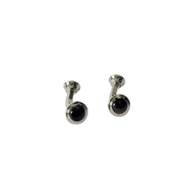 A pair of silver-toned cufflinks with round Brown fiberglass