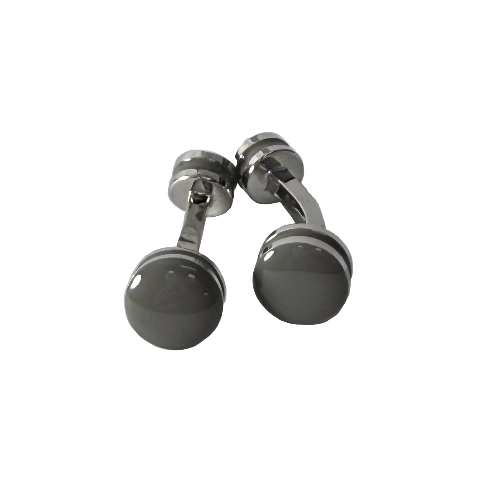 A pair of silver-toned cufflinks with round, polished dark gray to black faceted front discs, photographed on a light gray textured surface.
