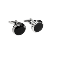 Pair of silver cufflinks with black circular stones on a white background