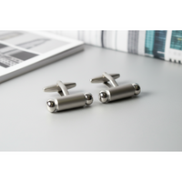 Premium men's cufflinks featuring a sleek silver design with polished accents for the modern gentleman.