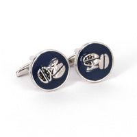 A pair of blue cufflinks with silver coffee bean designs on a white background.