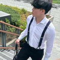 Orobianco stripe suspender in blue, white, and yellow stripe worn by a man in a white shirt and black pants.