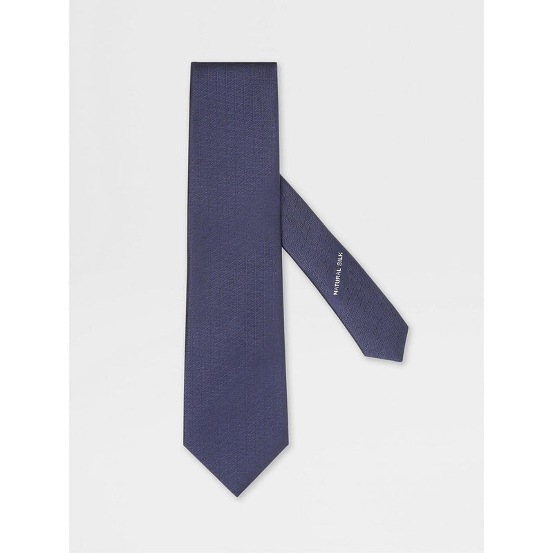 Navy blue tie with a brand logo on a light gray background