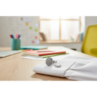Black horizontal stripe cufflinks on a white shirt, showcasing modern style in a contemporary workspace.