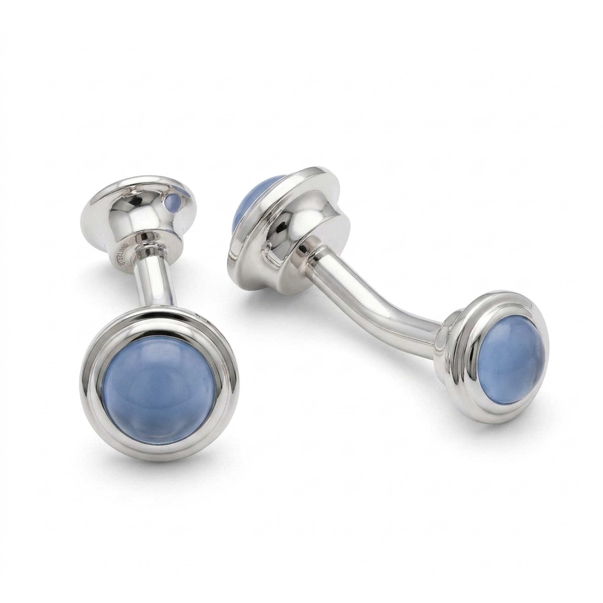 A pair of silver-toned labret piercing studs with smooth, oval light blue cat eye, displayed on a clean white background.