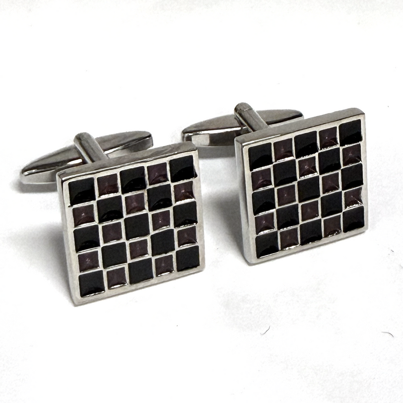 Pair of square cufflinks with black and silver checkered pattern on a white background