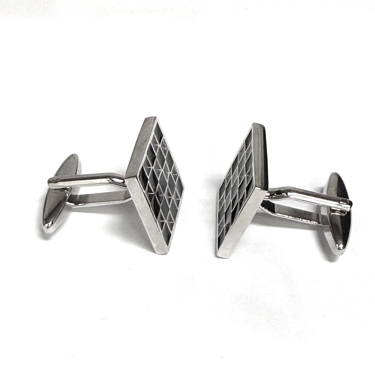 Silver geometric cufflinks on a white background