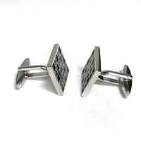 Silver geometric cufflinks on a white background