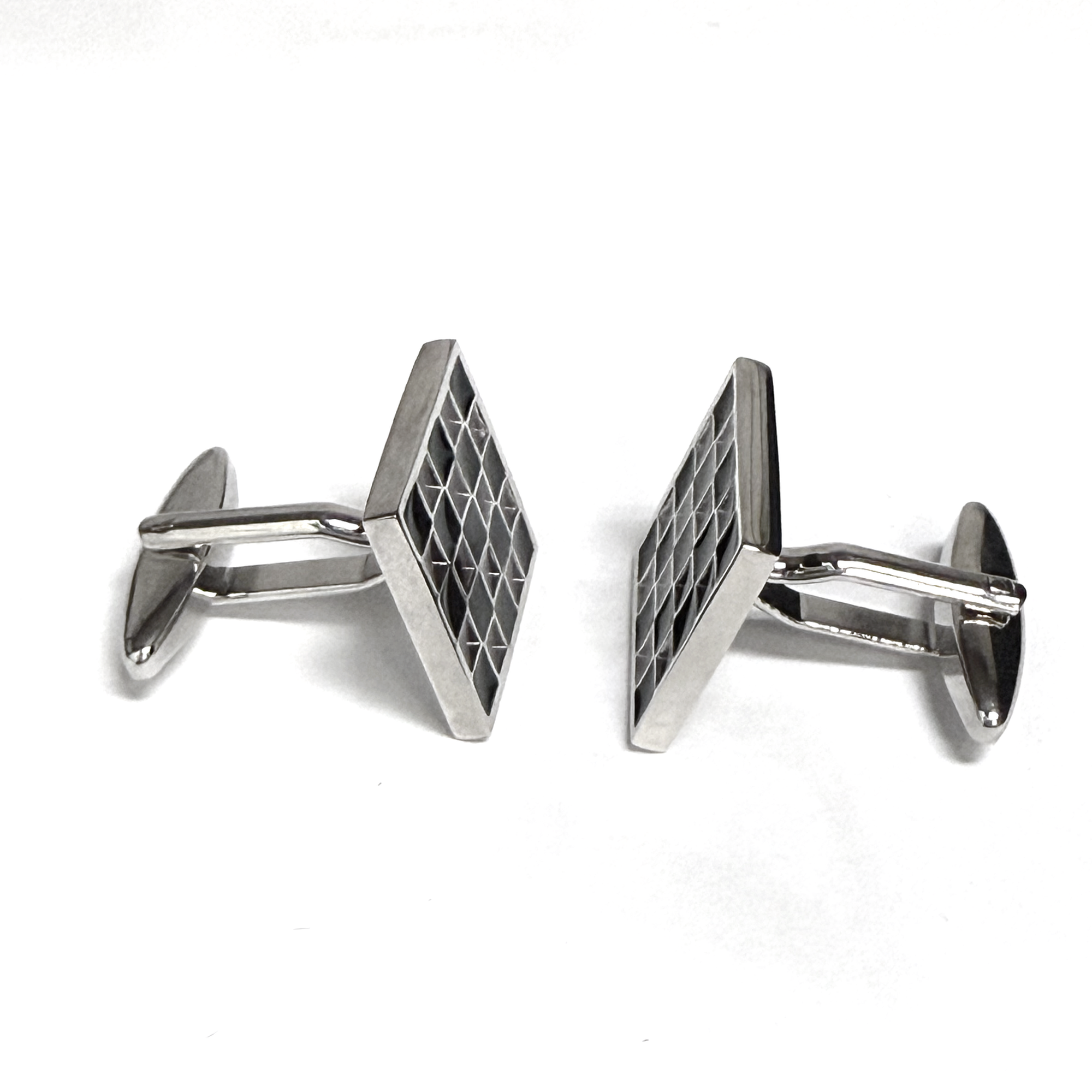Silver geometric cufflinks on a white background